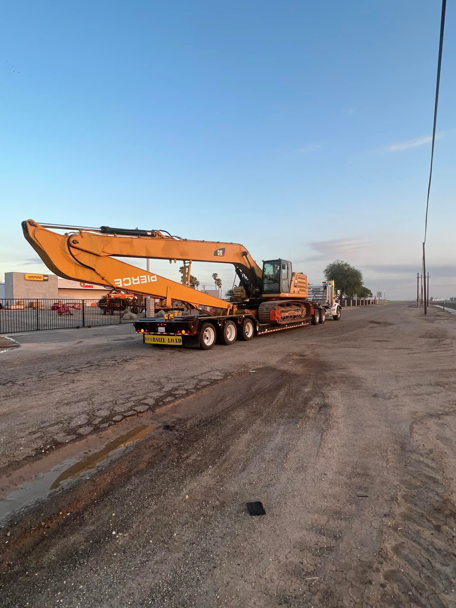 Truck carrying an excavator