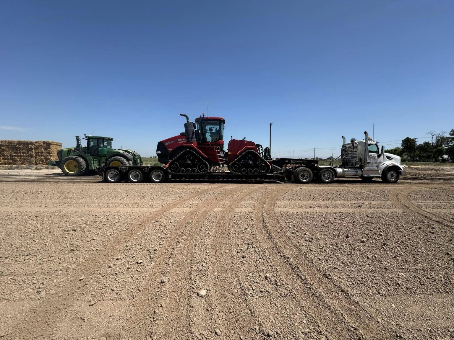 A tractor, a tractor crawler with triangle wheels and a truck